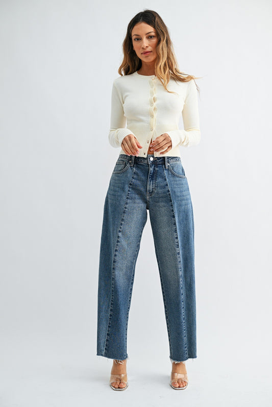 Medium wash pleated barrel jeans. Zipper and button closure with a cropped and raw edge.