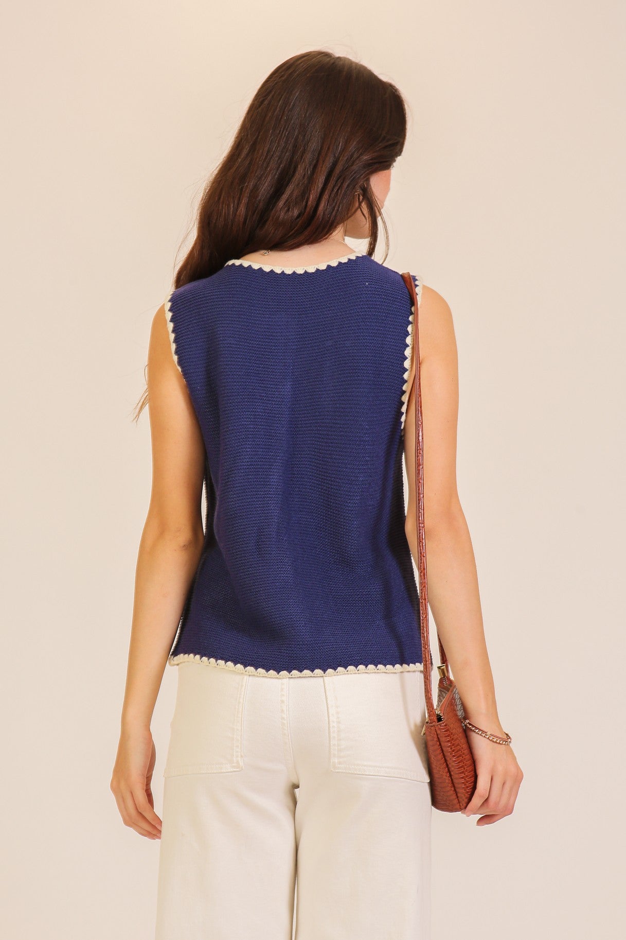 A women's sleeveless textured knit button-down vest tank top in navy featuring a ivory scalloped contrast trim along the neckline, front placket, armholes, and hem.