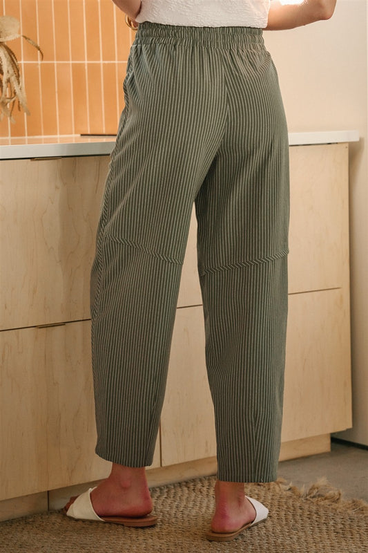 Olive and oatmeal vertical striped linen-blend pants featuring a high-rise elastic drawstring waistband, a relaxed tapered leg, and functional side utility pockets.