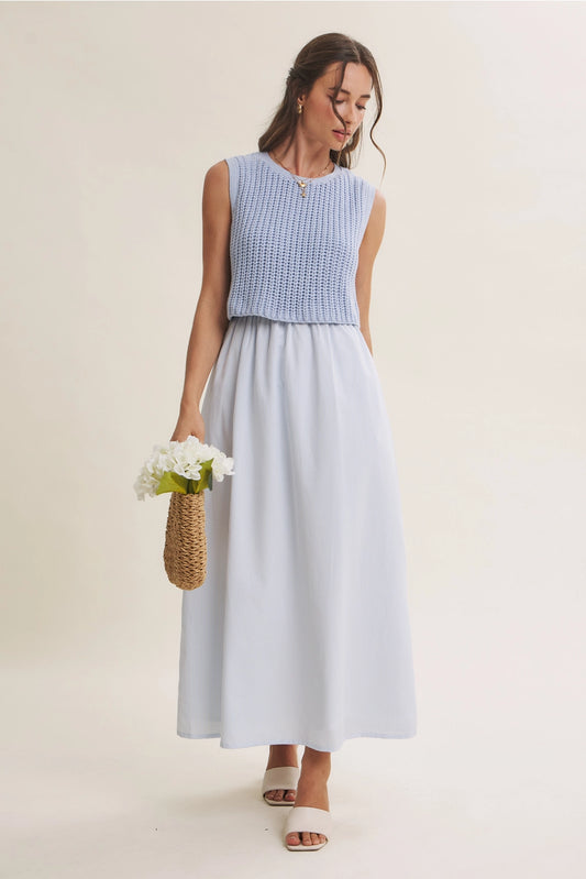 A women's sky blue mixed media midi dress featuring a sleeveless open-knit sweater vest top and an attached gathered striped midi skirt.