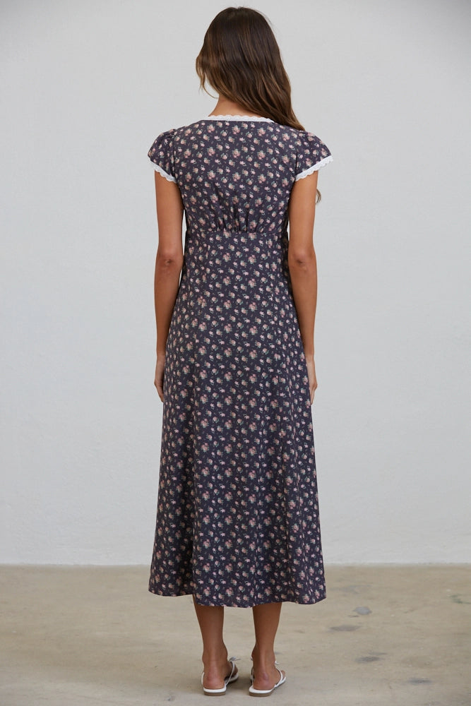 A women's short flutter sleeve midi dress in antique black featuring a pink vintage rose floral print, white scalloped lace trim along the V-neckline, and a full button-down front.