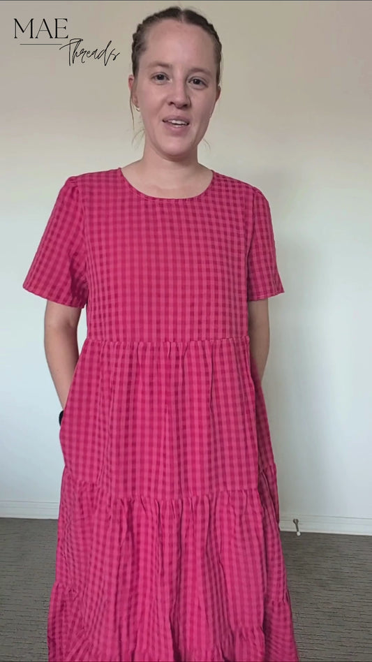 The Garnet Gingham Tiered Midi Dress in Hot Pink