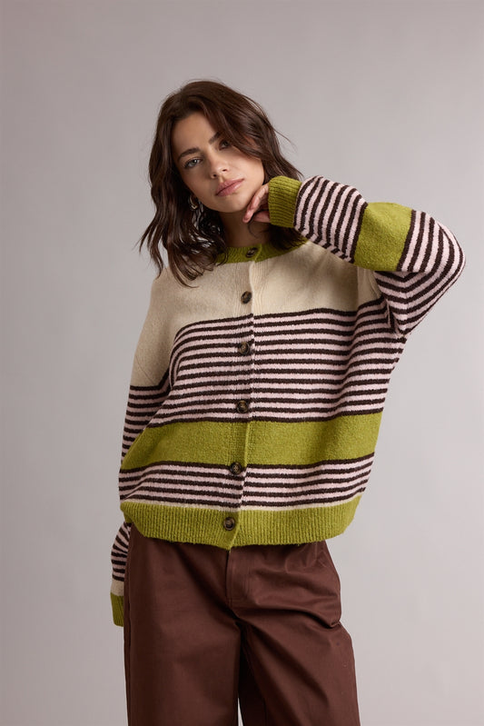 A women's relaxed crewneck knit cardigan featuring wide avocado green colorblocking and horizontal espresso stripes on a cream background with tortoiseshell-look front buttons.
