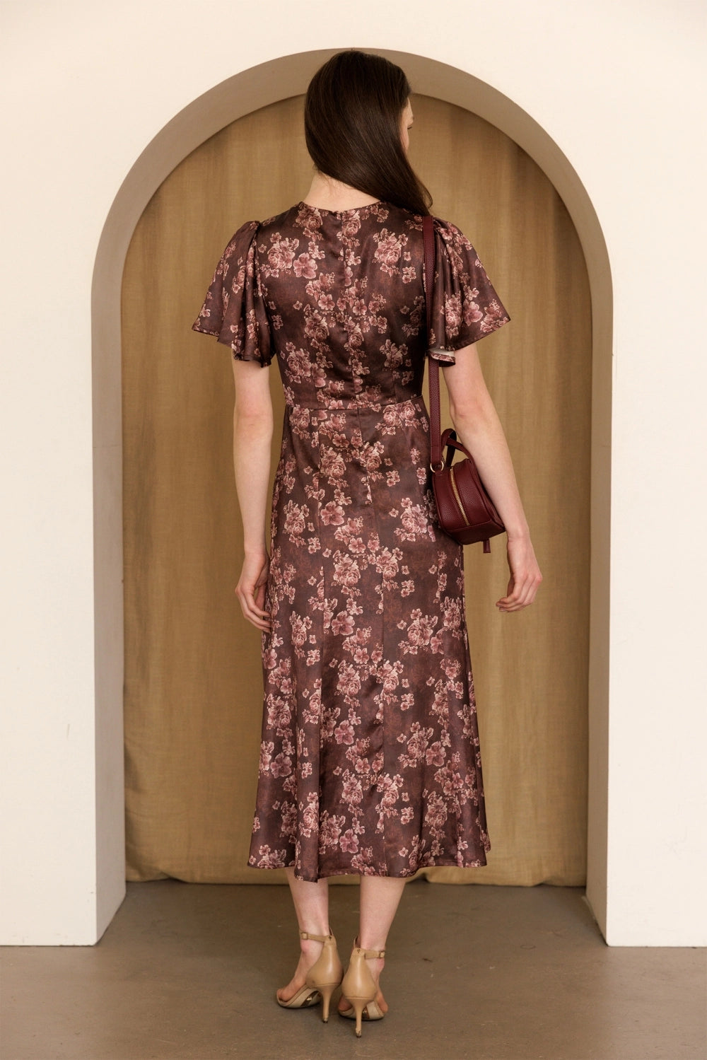A women's dusty mauve floral print midi dress featuring short flutter sleeves, a structured smocked bodice, and an A-line skirt