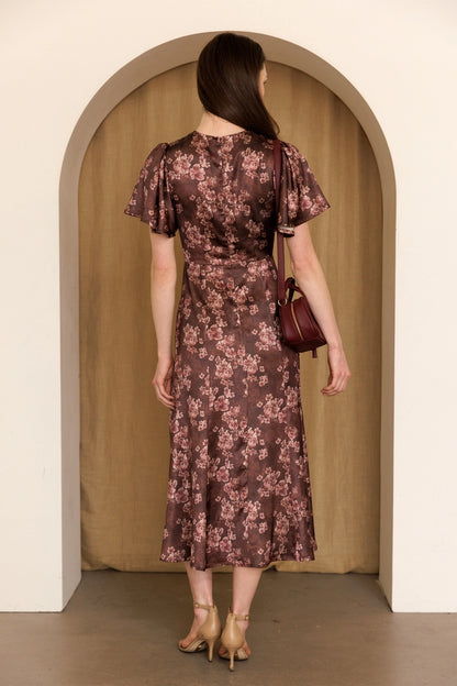 A women's dusty mauve floral print midi dress featuring short flutter sleeves, a structured smocked bodice, and an A-line skirt