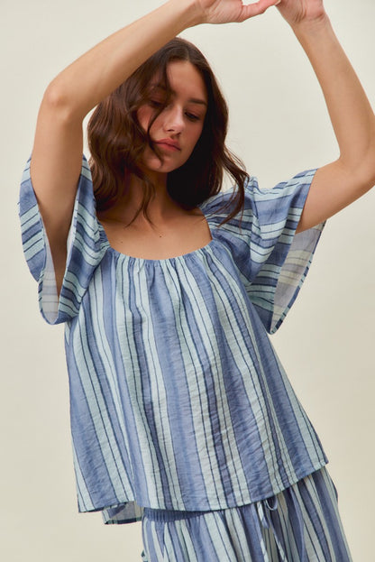 A women's lightweight square-neck blouse featuring vertical stripes in blue tones with loose flutter sleeves and a relaxed fit.