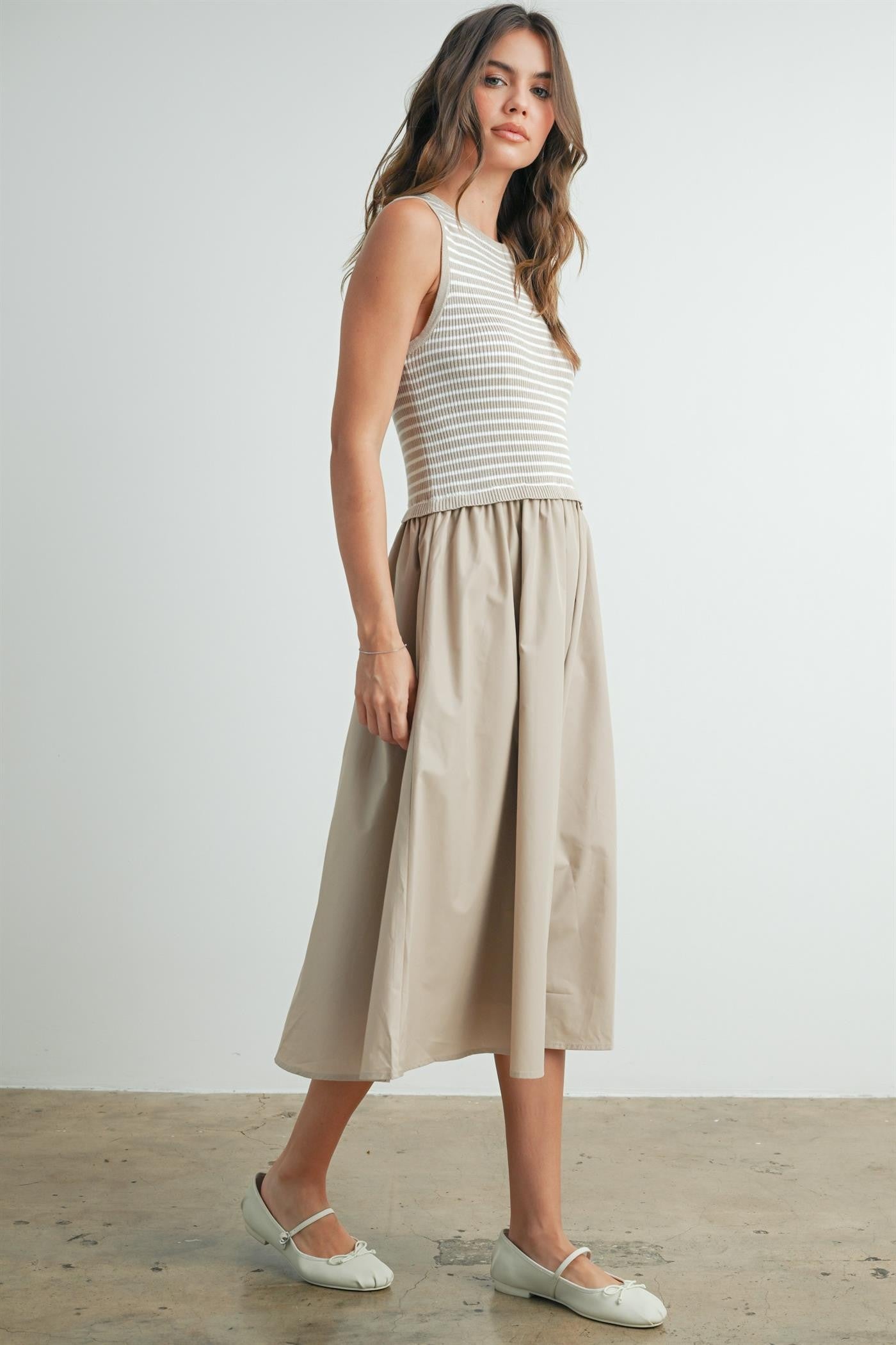 Striped sleeveless dress in taupe and ivory. Contains a solid flowy cotton bottom with a striped smocked top. 