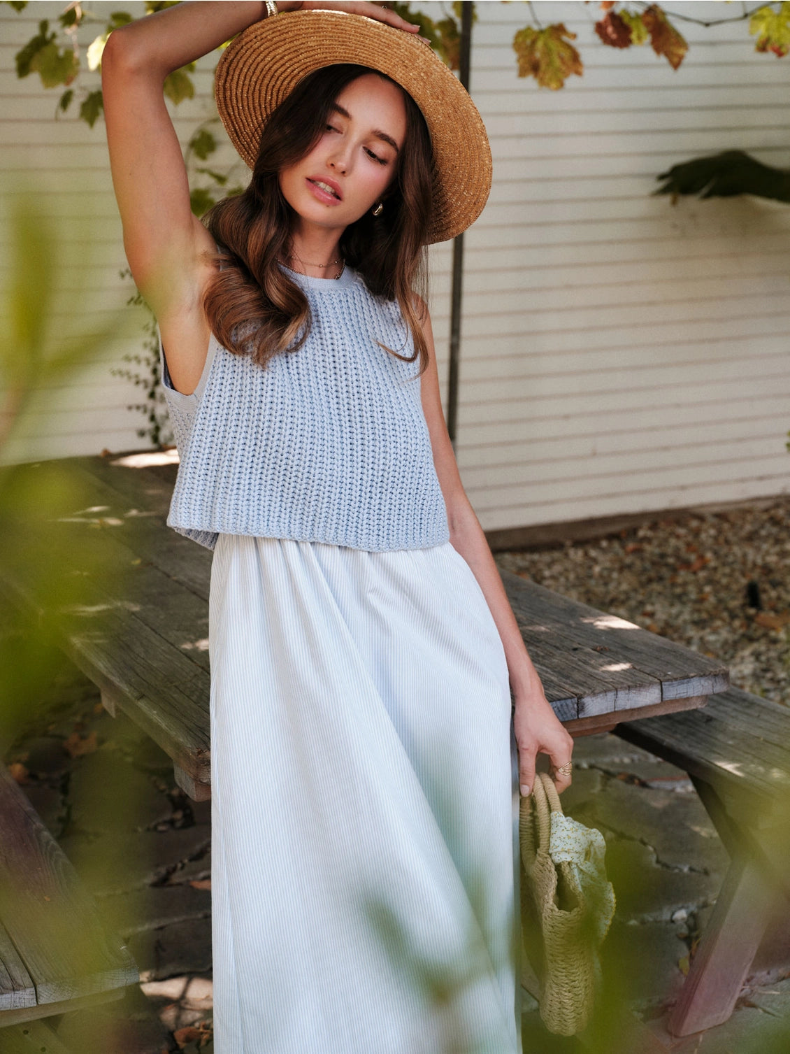 A women's sky blue mixed media midi dress featuring a sleeveless open-knit sweater vest top and an attached gathered striped midi skirt.