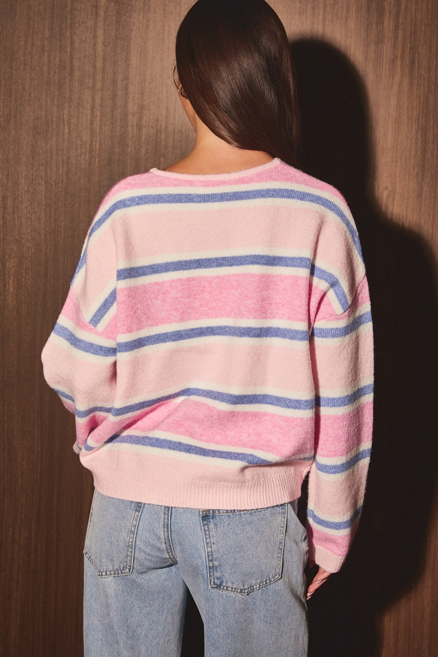 A women's light pink, white, and periwinkle blue horizontally striped long-sleeve knit cardigan sweater featuring a crew neckline, front button placket, and relaxed drop shoulders.