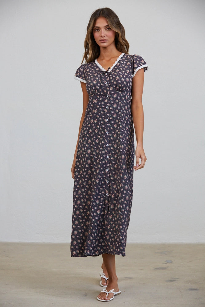 A women's short flutter sleeve midi dress in antique black featuring a pink vintage rose floral print, white scalloped lace trim along the V-neckline, and a full button-down front.
