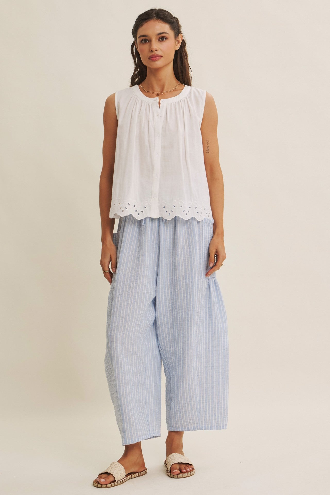 Striped Pants offer a relaxed fit, an elastic waistband with adjustable drawstring with voluminous legs and dropped side pockets in light blue. 
