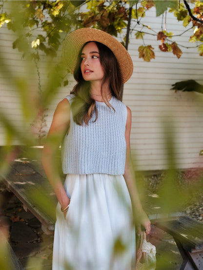 A women's sky blue mixed media midi dress featuring a sleeveless open-knit sweater vest top and an attached gathered striped midi skirt.