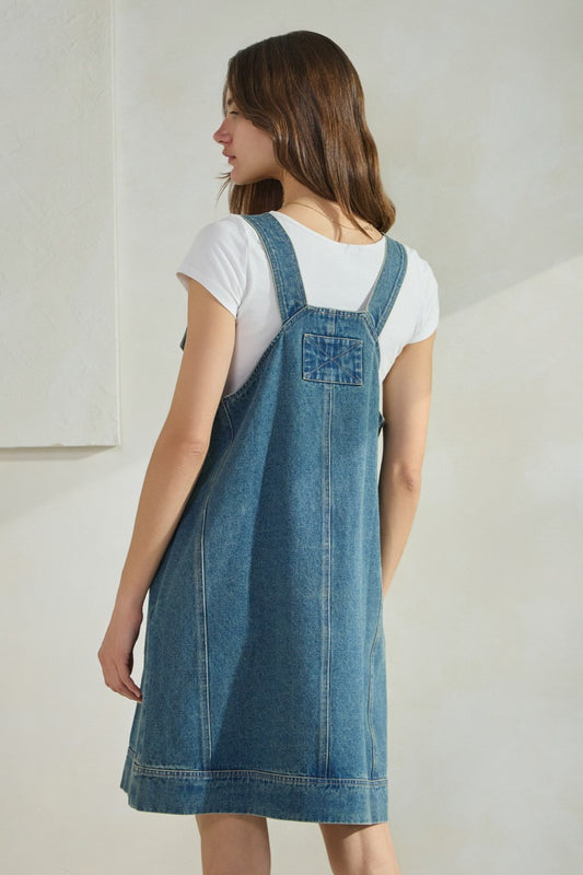 Overall denim dress with large front pocket and side pockets.