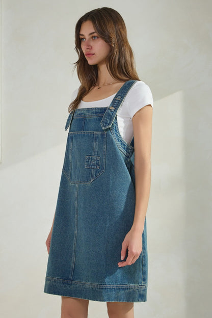 Overall denim dress with large front pocket and side pockets.