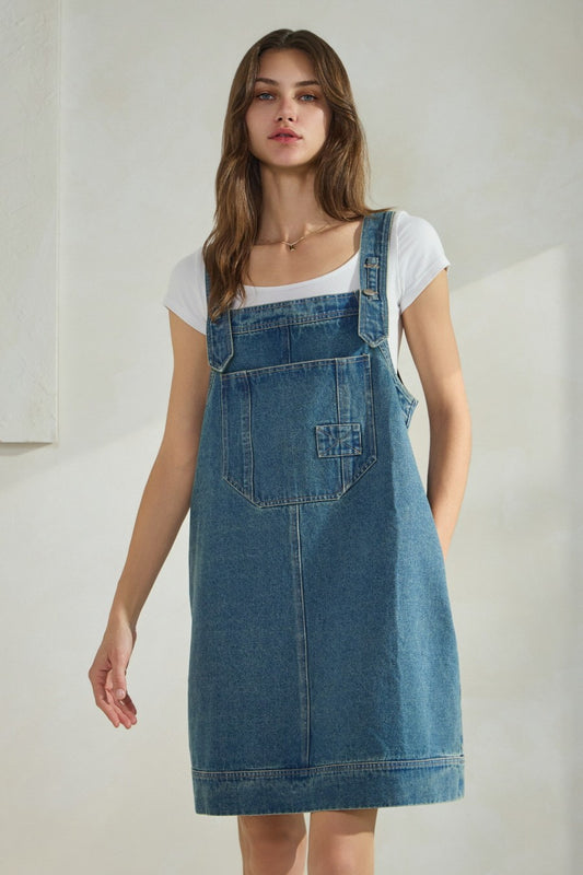 Overall denim dress with large front pocket and side pockets.