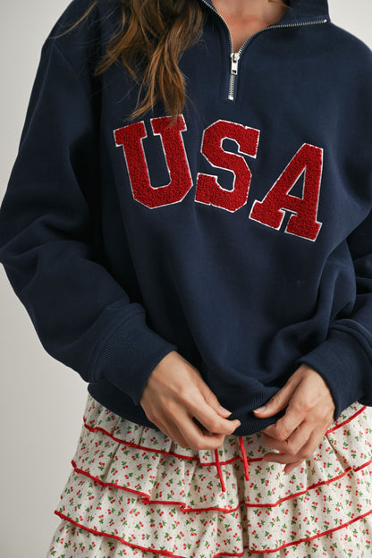 Long-sleeve pullover, half-zip navy sweater with felted USA in the center. 