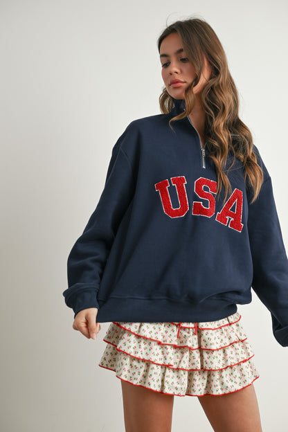 Long-sleeve pullover, half-zip navy sweater with felted USA in the center. 