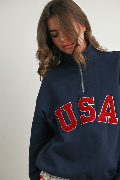 Long-sleeve pullover, half-zip navy sweater with felted USA in the center. 