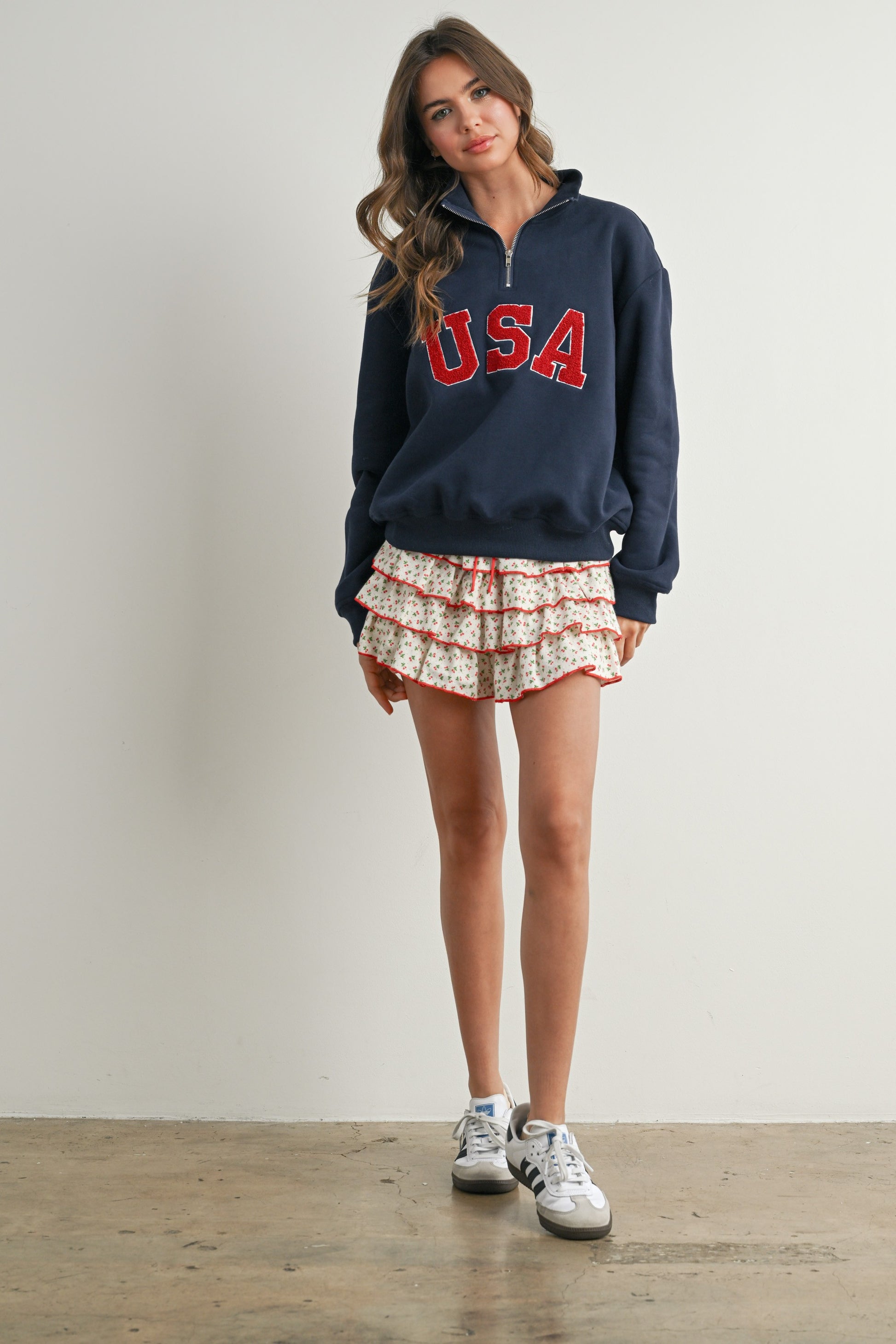 Long-sleeve pullover, half-zip navy sweater with felted USA in the center. 