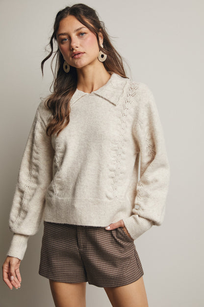 Soft Knit Fabric
Pointelle Detailing
Collared Neckline
Relaxed Silhouette
Balloon Sleeves
Ribbed Trim