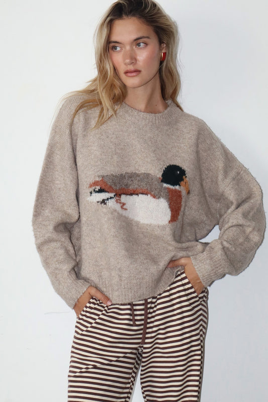 Knit sweater in taupe with a duck graphic in the center. 