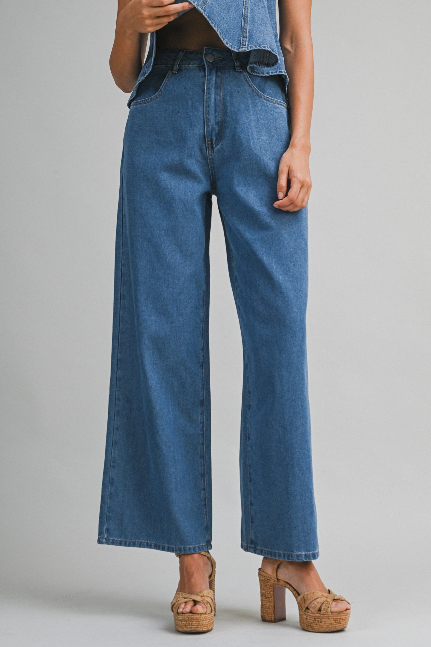 Denim sleeveless peplum top and matching wide jean pants with front button set. 