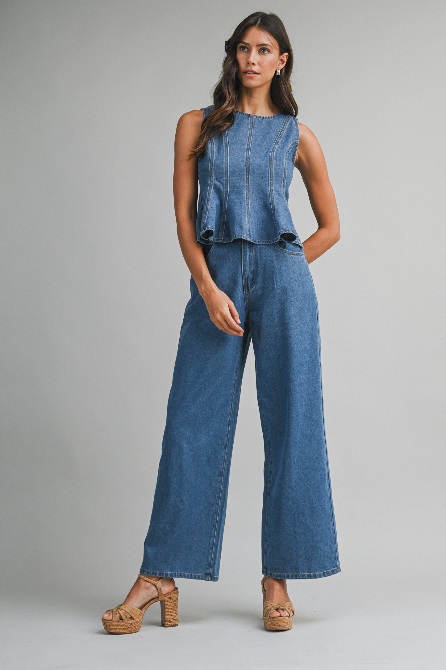 Denim sleeveless peplum top and matching wide jean pants with front button set. 