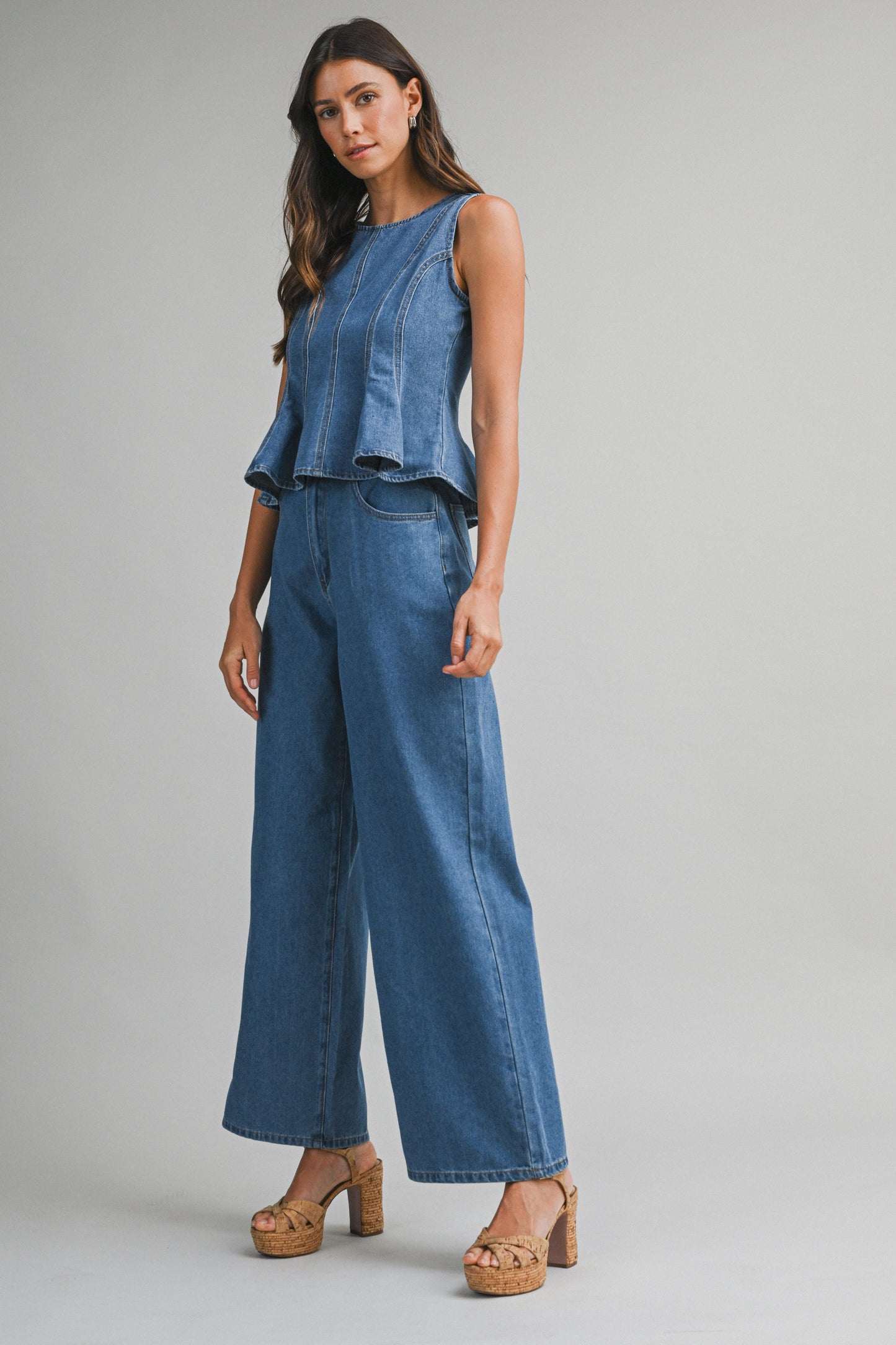 Denim sleeveless peplum top and matching wide jean pants with front button set. 