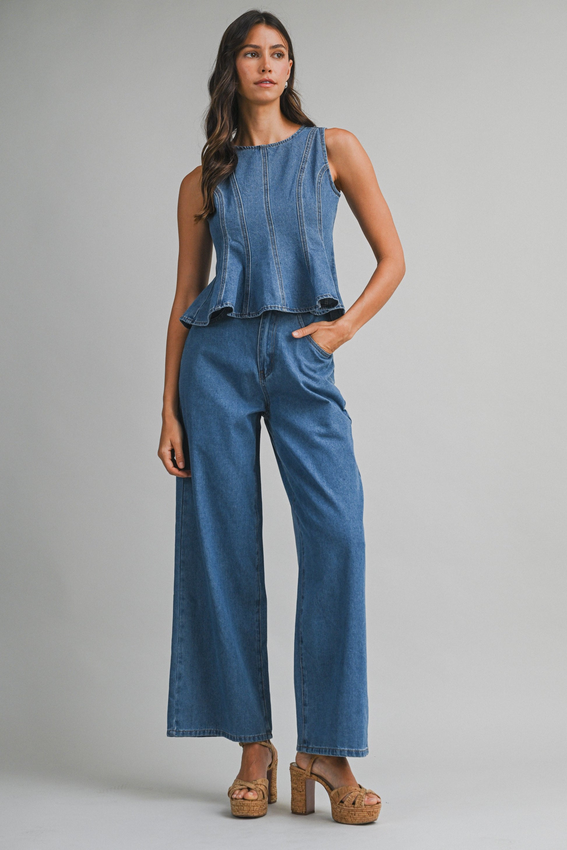 Denim sleeveless peplum top and matching wide jean pants with front button set. 