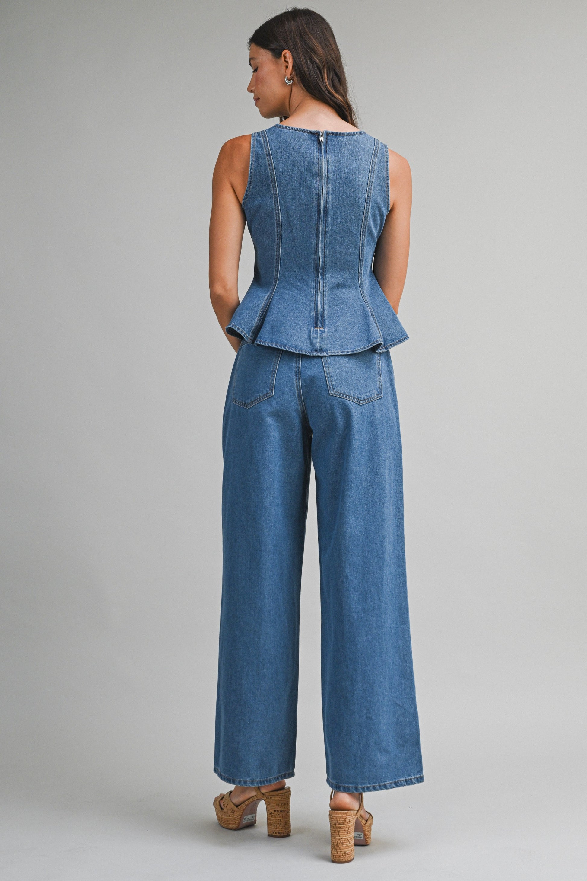 Denim sleeveless peplum top and matching wide jean pants with front button set. 