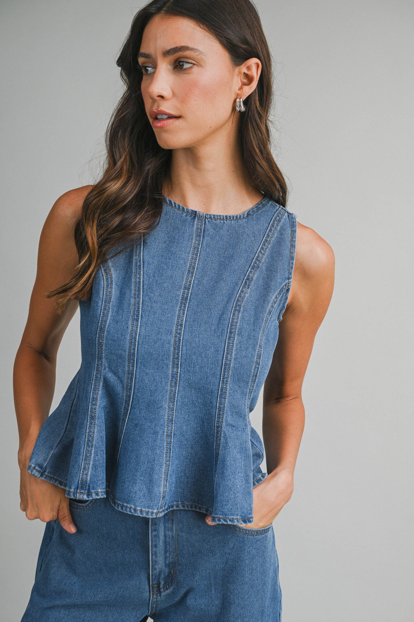 Denim sleeveless peplum top and matching wide jean pants with front button set. 