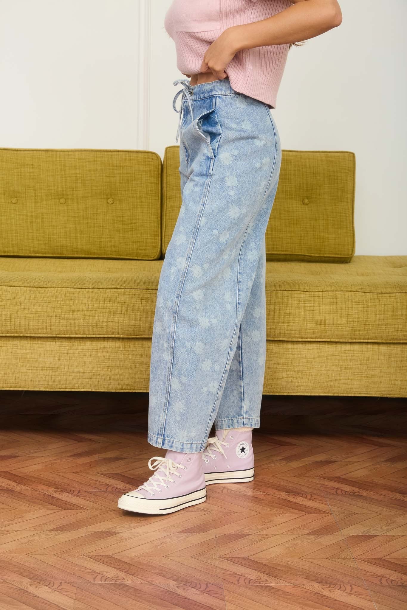 Dandelion printed cropped slight barrel light wash denim jeans. Button and zipper closure with a waist tie. 