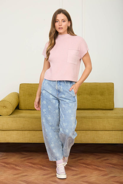 Dandelion printed cropped slight barrel light wash denim jeans. Button and zipper closure with a waist tie. 