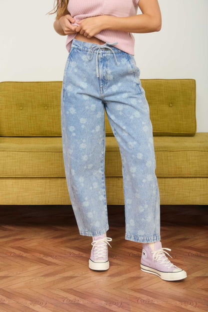 Dandelion printed cropped slight barrel light wash denim jeans. Button and zipper closure with a waist tie. 
