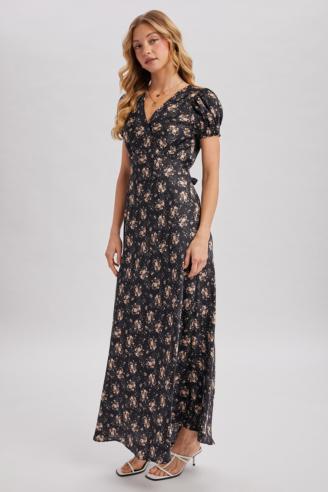 Black maxi dress with ditsy floral pattern. Surplice v-neckline
Short, puffed sleeves that are gathered at the cuffs. 
Flowing A-line skirt 