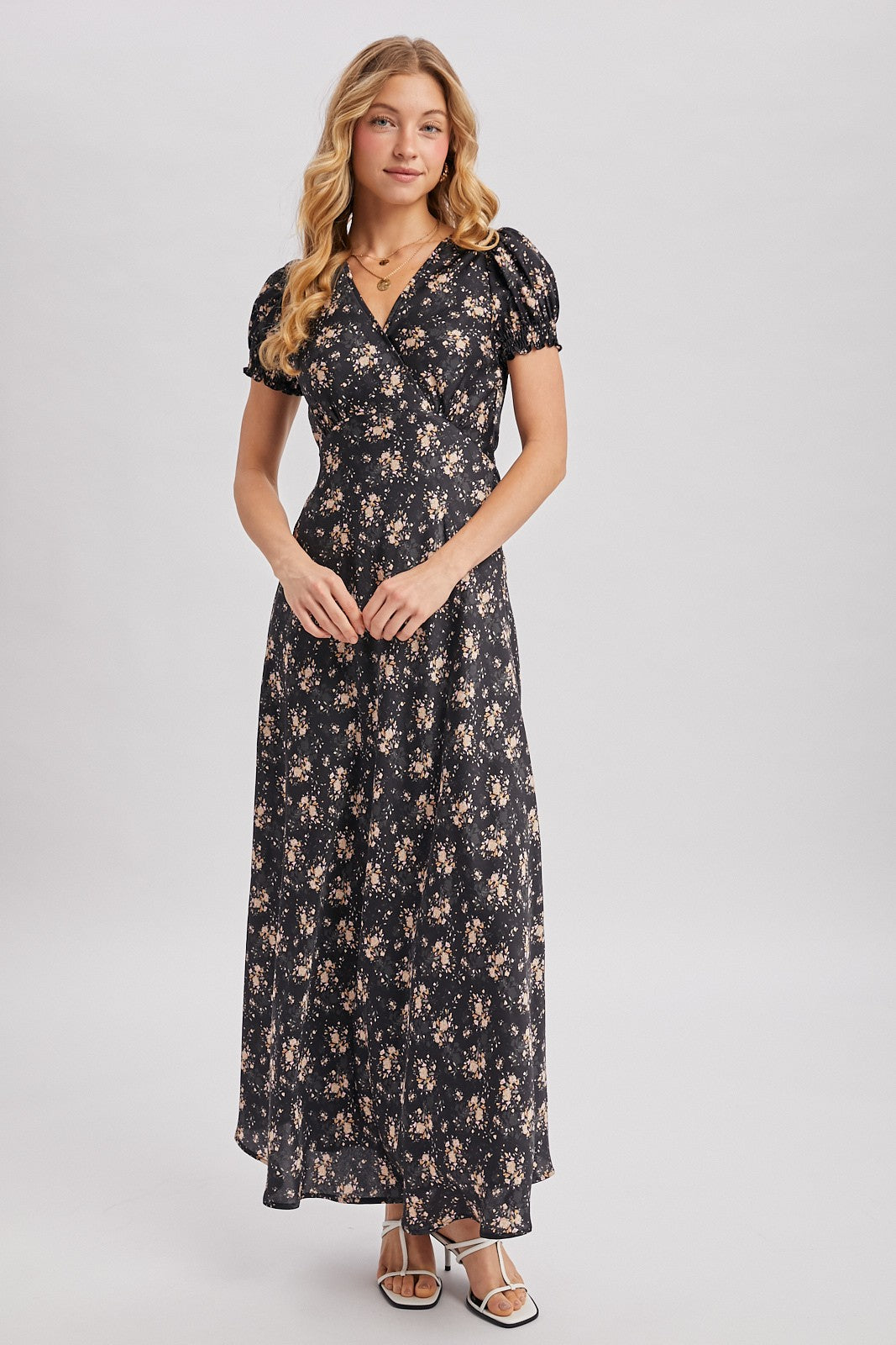 Black maxi dress with ditsy floral pattern. Surplice v-neckline
Short, puffed sleeves that are gathered at the cuffs. 
Flowing A-line skirt 