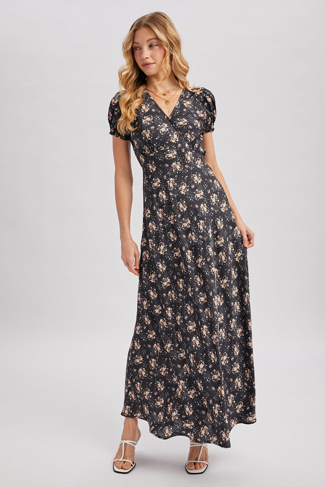 Black maxi dress with ditsy floral pattern. Surplice v-neckline
Short, puffed sleeves that are gathered at the cuffs. 
Flowing A-line skirt 