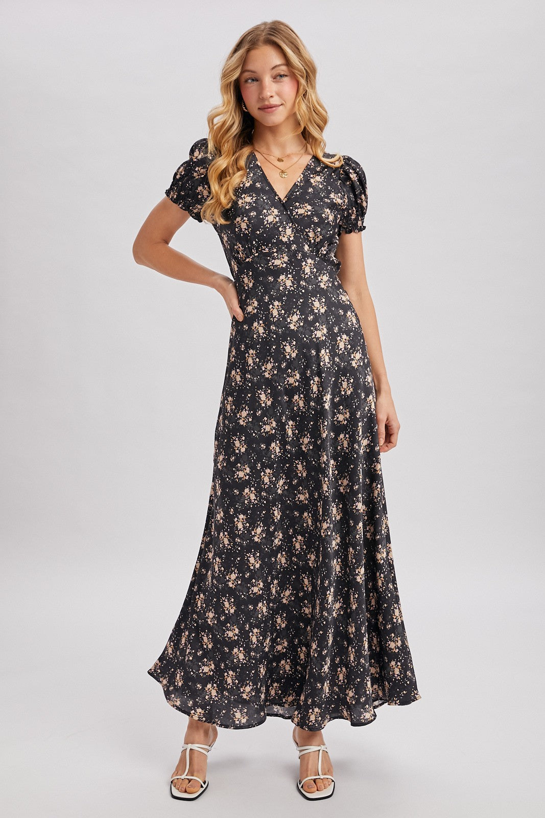 Black maxi dress with ditsy floral pattern. Surplice v-neckline
Short, puffed sleeves that are gathered at the cuffs. 
Flowing A-line skirt 
