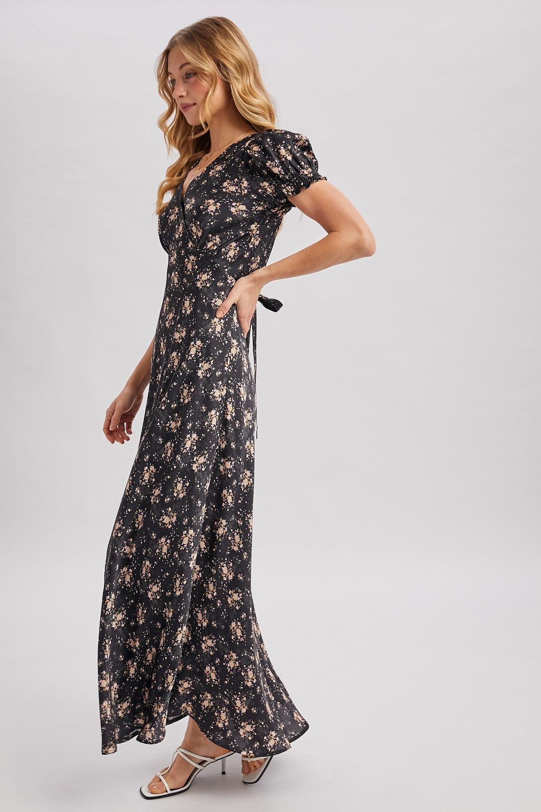 Black maxi dress with ditsy floral pattern. Surplice v-neckline
Short, puffed sleeves that are gathered at the cuffs. 
Flowing A-line skirt 