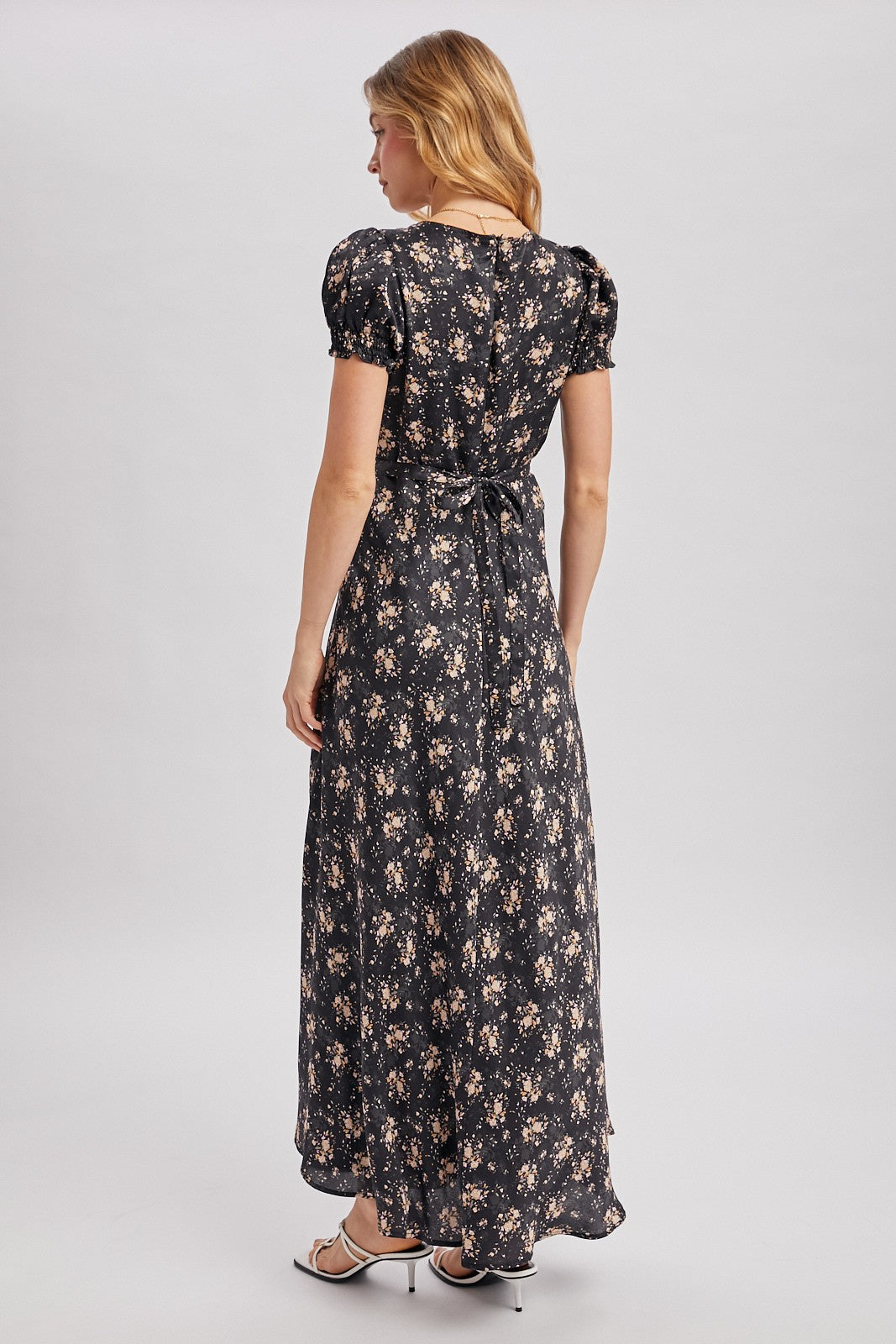 Black maxi dress with ditsy floral pattern. Surplice v-neckline
Short, puffed sleeves that are gathered at the cuffs. 
Flowing A-line skirt 