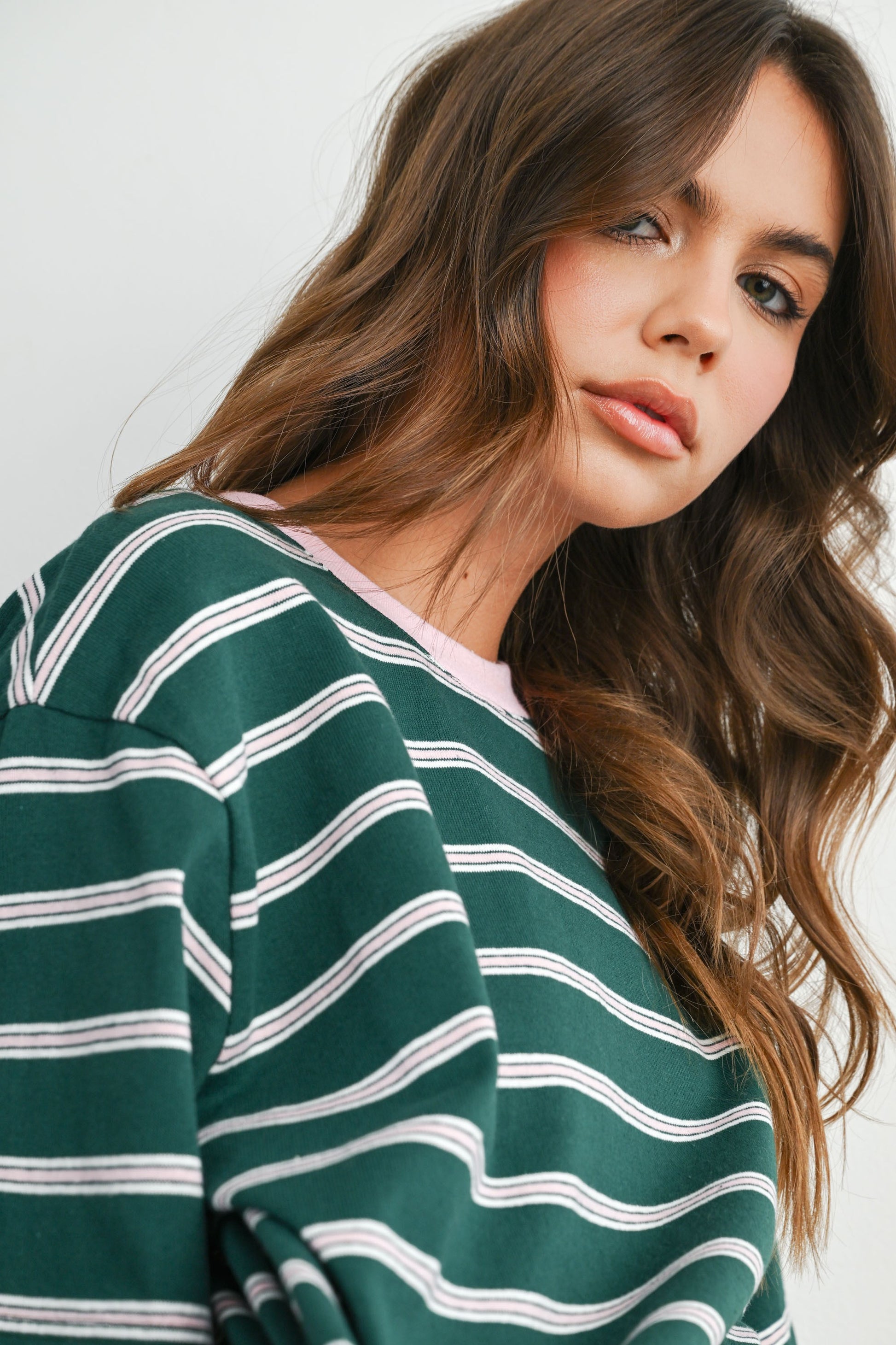 Boxy cut green and light pink striped cropped tee. 