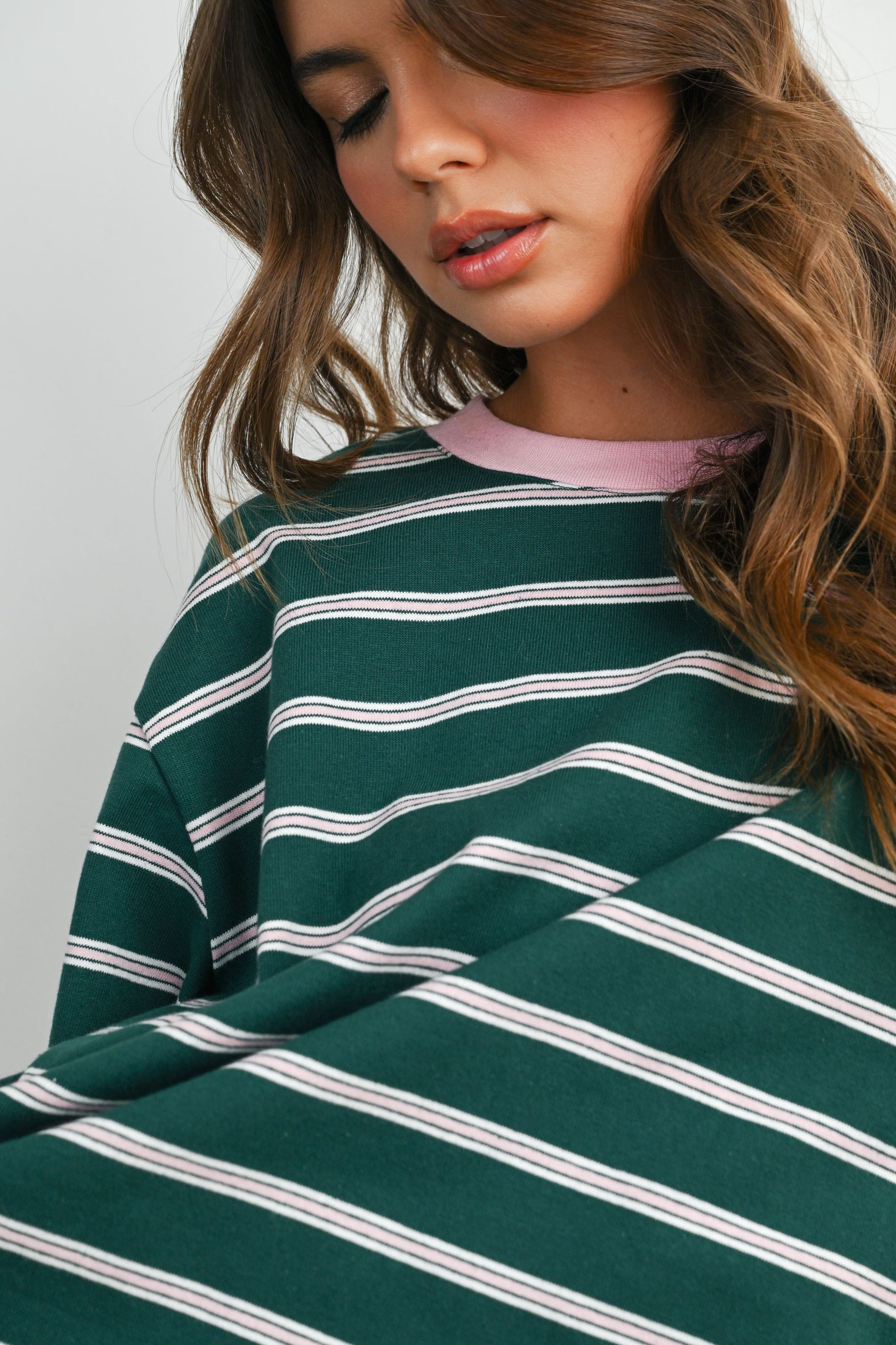 Boxy cut green and light pink striped cropped tee. 