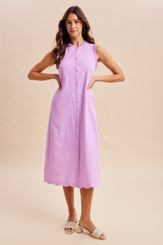 Sleeveless Button-Down Midi Dress with scalloped hem, ruffled mock neck, and ruffled armholes.  Button-down front closure and tie-waist detail, side pockets, and an inner lining.