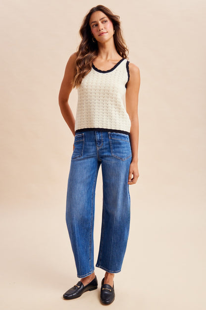 Stretch denim slim barrel leg jeans in dark wash denim featuring a high-rise waist, angled front utility patch pockets, and distinct center seam detailing down each leg.