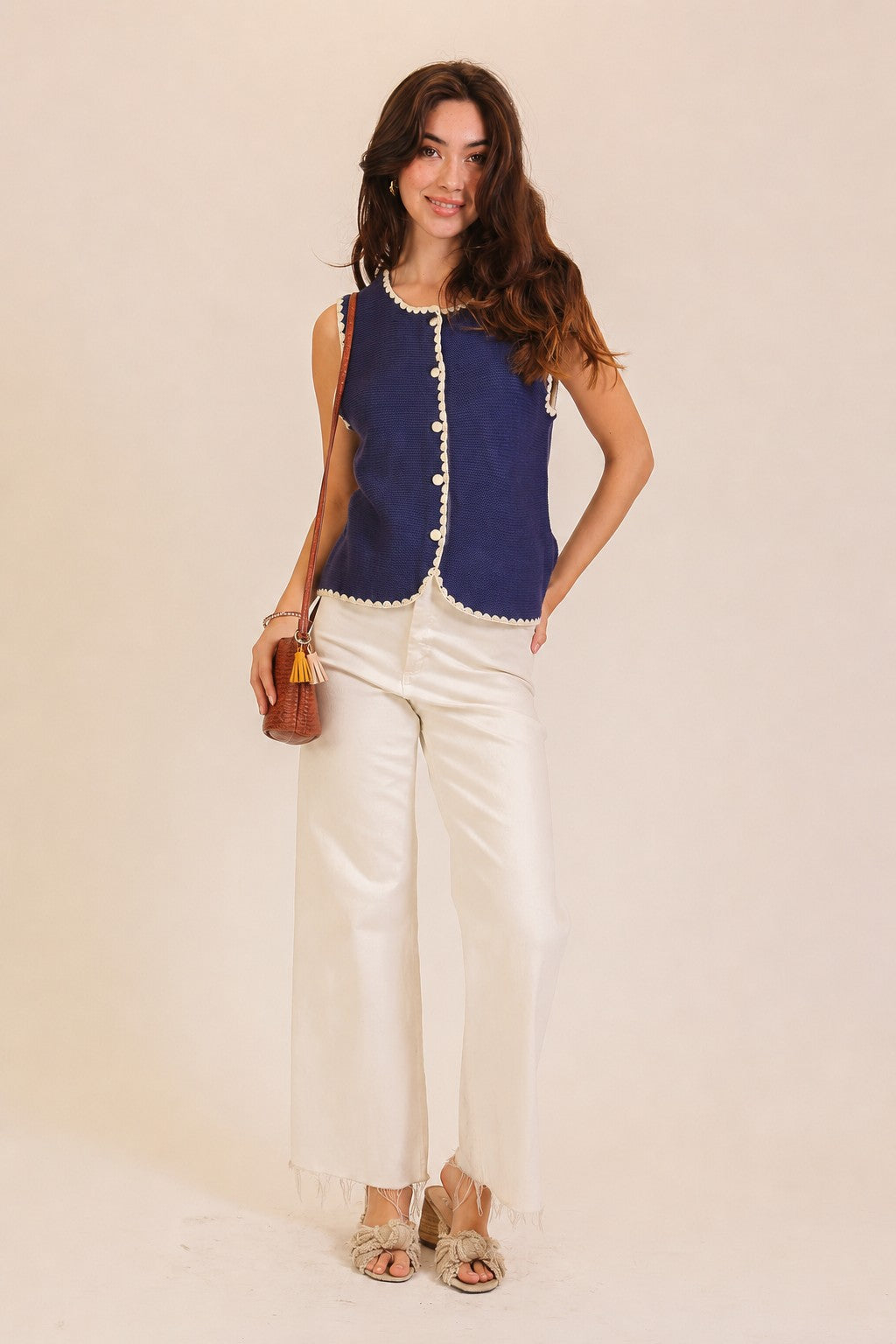 A women's sleeveless textured knit button-down vest tank top in navy featuring a ivory scalloped contrast trim along the neckline, front placket, armholes, and hem.