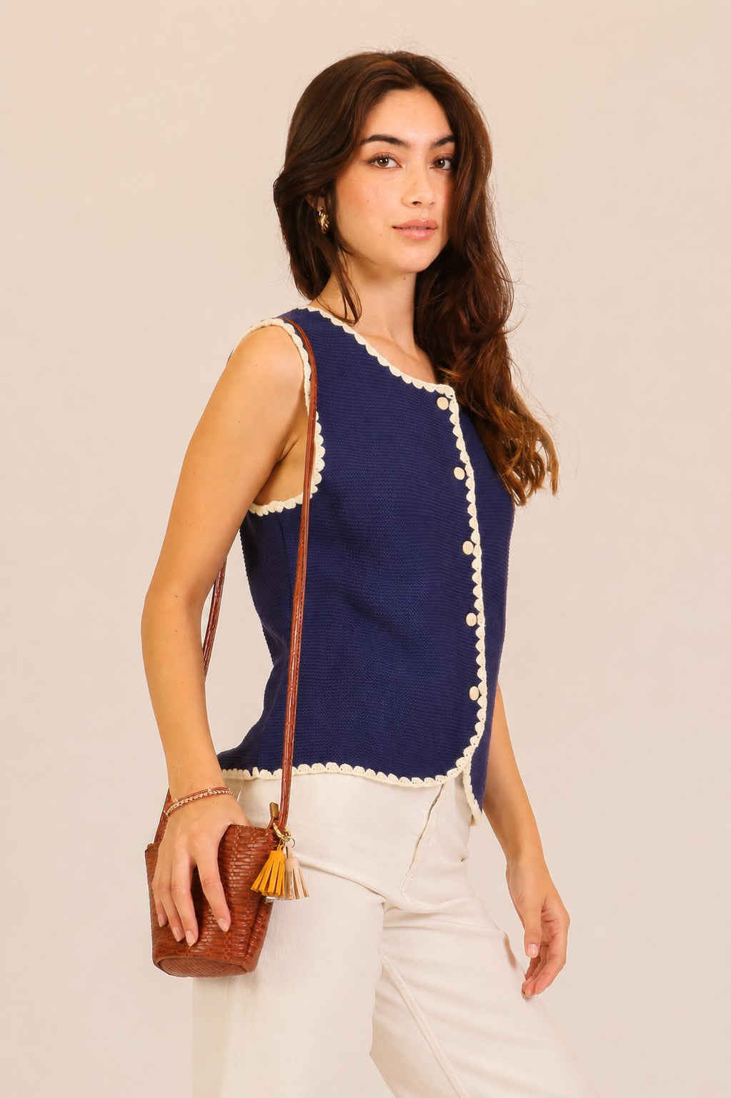 A women's sleeveless textured knit button-down vest tank top in navy featuring a ivory scalloped contrast trim along the neckline, front placket, armholes, and hem.