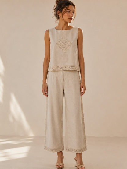 A women's two-piece linen-blend clothing set in an oat color featuring a sleeveless top with a chest diamond crochet applique and matching high-waisted wide-leg pants with lace trim panels along the sides and hems.