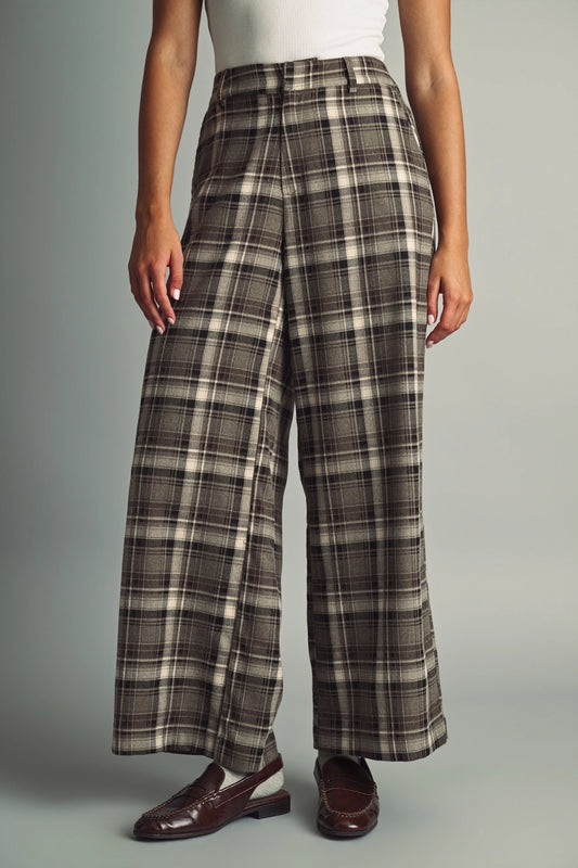 A women's high-waisted wide-leg plaid trousers in black and warm brown featuring front pleats, belt loops, and a relaxed straight drape.