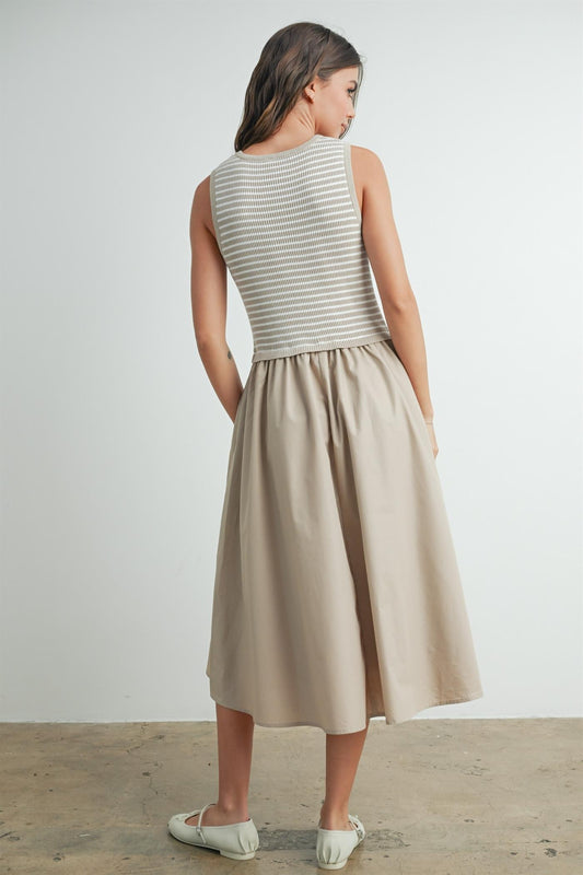 Striped sleeveless dress in taupe and ivory. Contains a solid flowy cotton bottom with a striped smocked top. 