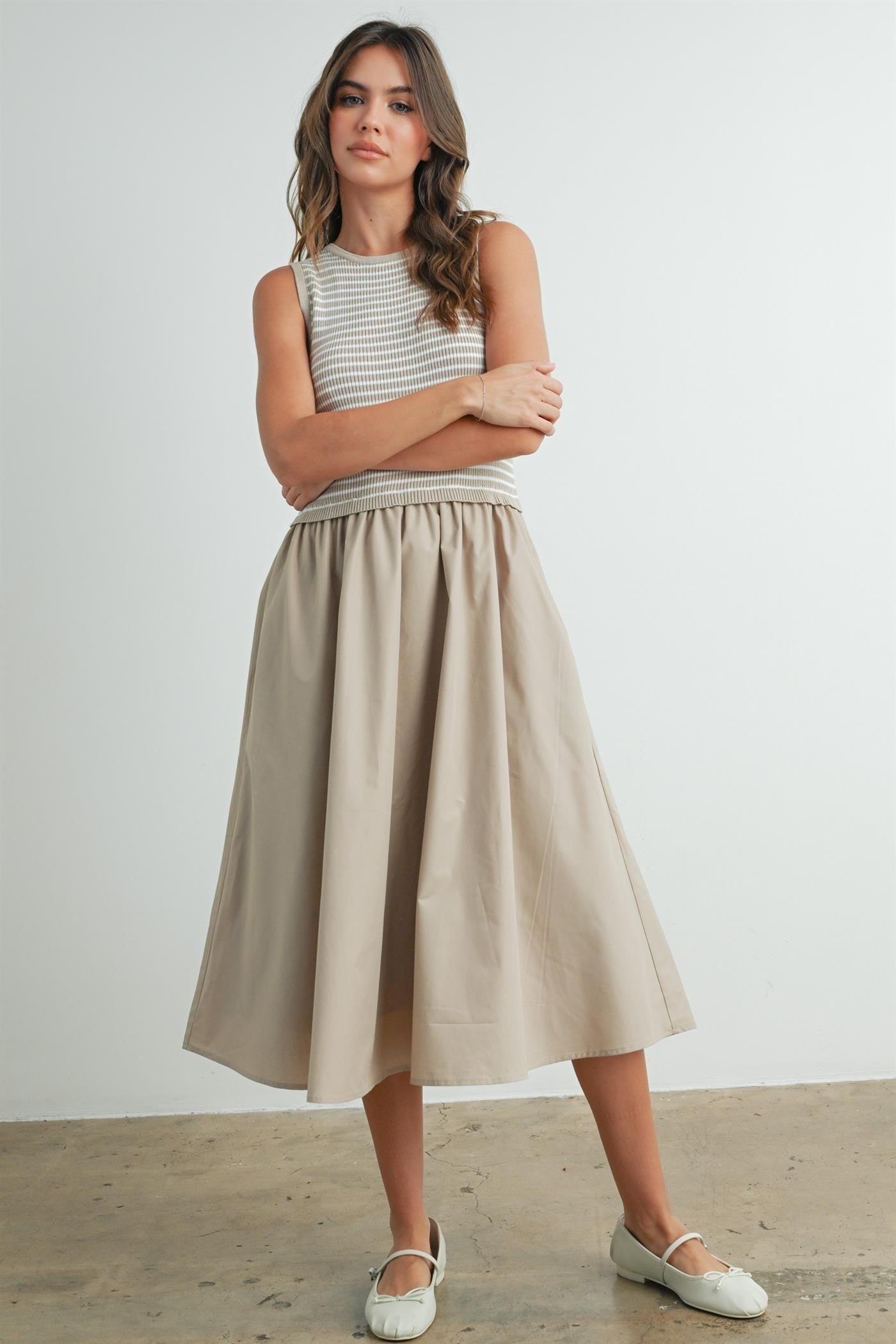 Striped sleeveless dress in taupe and ivory. Contains a solid flowy cotton bottom with a striped smocked top. 
